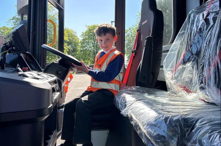 Loddon Primary School pupil Jack at the wheel of a new waste vehicle