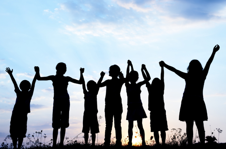 Silhouette of children holding hands 