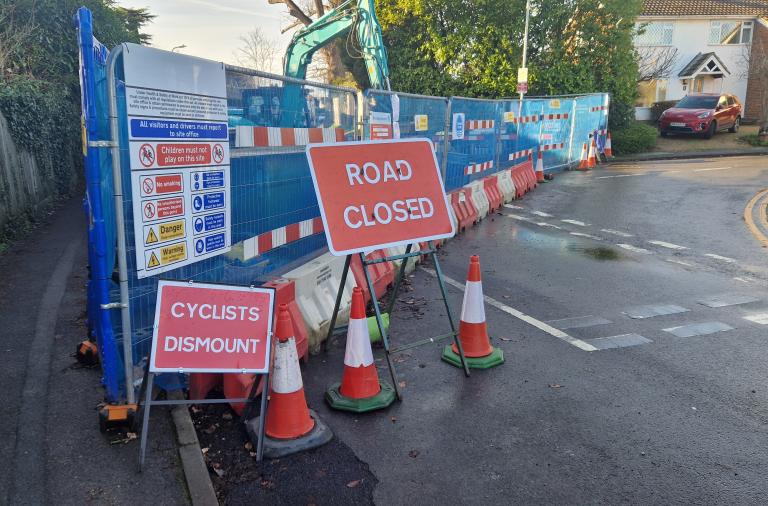 Thames Water's roadworks at Evendons Lane in January 2026, with barriers across the road and signs indicating the closure