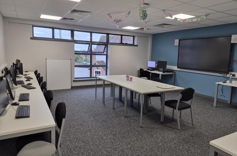A room with computer screens and keyboards at The Glade