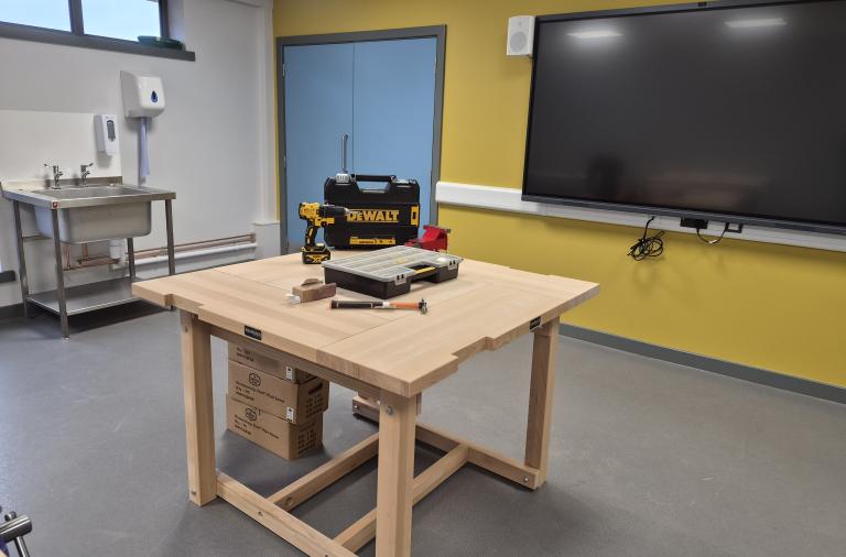 The multi-skills room showing a wooden table and tools