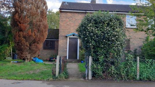 A house with the front door boarded up