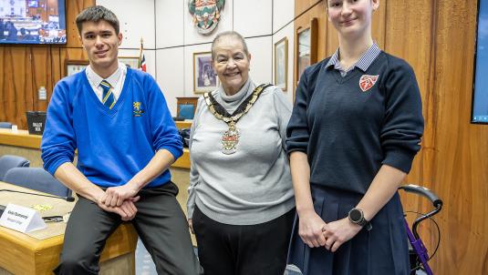 Borough mayor Beth Rowland stands in the council chambers between newly elected youth mp and vice youth mp