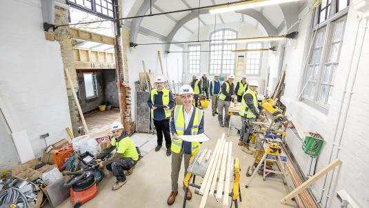 Cllr Stephen Conway and contractors in the main hall of the new Twyford Library 