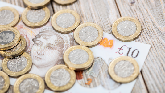 A decorative image of cash on a table