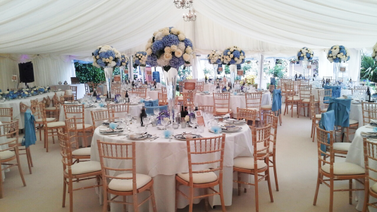 Photo of an indoor wedding, chairs in a marquee 