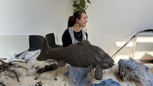 Artist creating a fish as part of the artwork going on display for Forest of Imagination