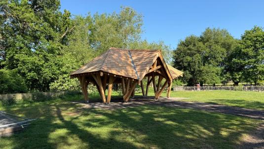 An open sided wooden shelter newly installed at Dinton Pastures