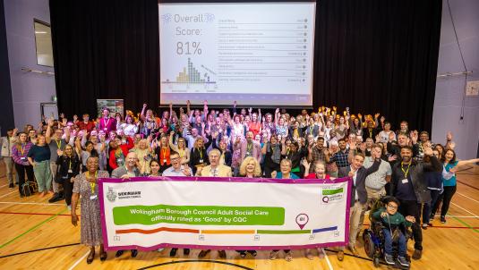 Colleagues with CQC result banner cheering
