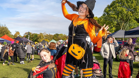 Witch on stilts at the pumpkin fair