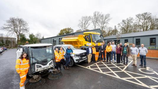 Depot staff and vehicles including gritter and road sweeper outside Toutley Depot.