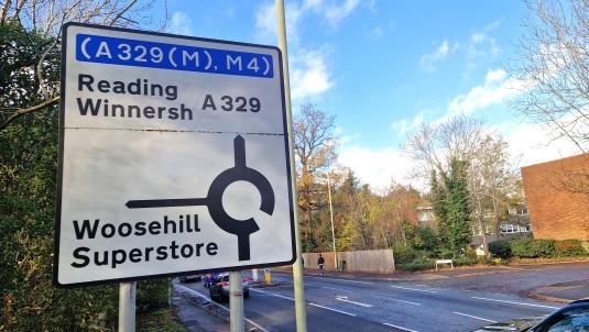 Big roadside sign showing the approach to Woosehill roundabout, with Reading and Winnersh ahead and Woosehill and superstore at first exit
