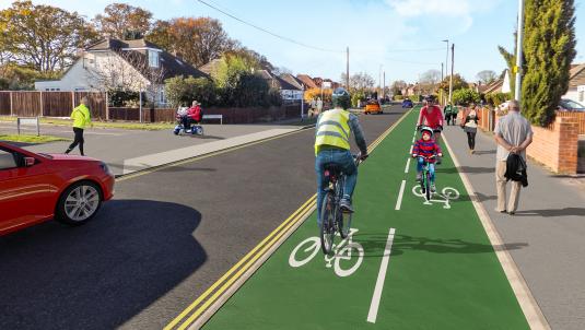 artist's impression of a cyclist riding down a new cycleway along Woodlands Avenue in Woodley, which is separate from both the road and the pavement