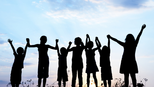 Silhouette of children holding hands 
