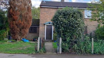 A house with the front door boarded up