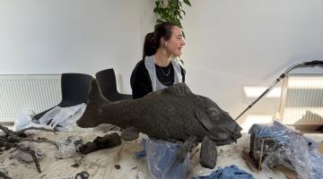 Artist creating a fish as part of the artwork going on display for Forest of Imagination