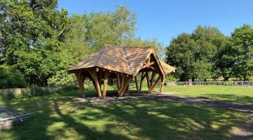 An open sided wooden shelter newly installed at Dinton Pastures