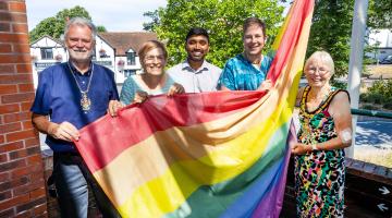 Wokingham Borough councillors raise the Pride rainbow flag at the council's Shute End offices