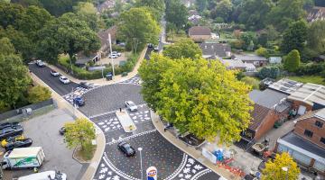 Aerial view of the new California Crossroads junction with level surface and multi-coloured leaf patterns painted on the carriageway