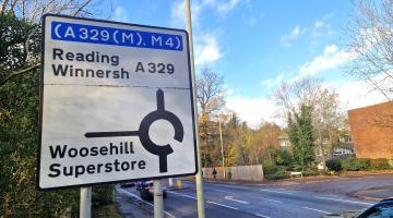 Big roadside sign showing the approach to Woosehill roundabout, with Reading and Winnersh ahead and Woosehill and superstore at first exit