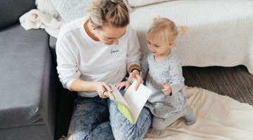 Mother and daughter sat reading a book