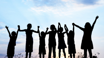 Silhouette of children holding hands 