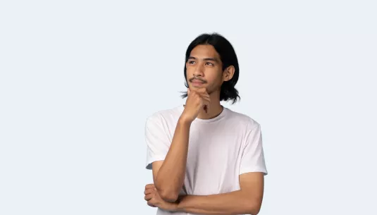 A teenager with his hand on his chin, looking thoughtful