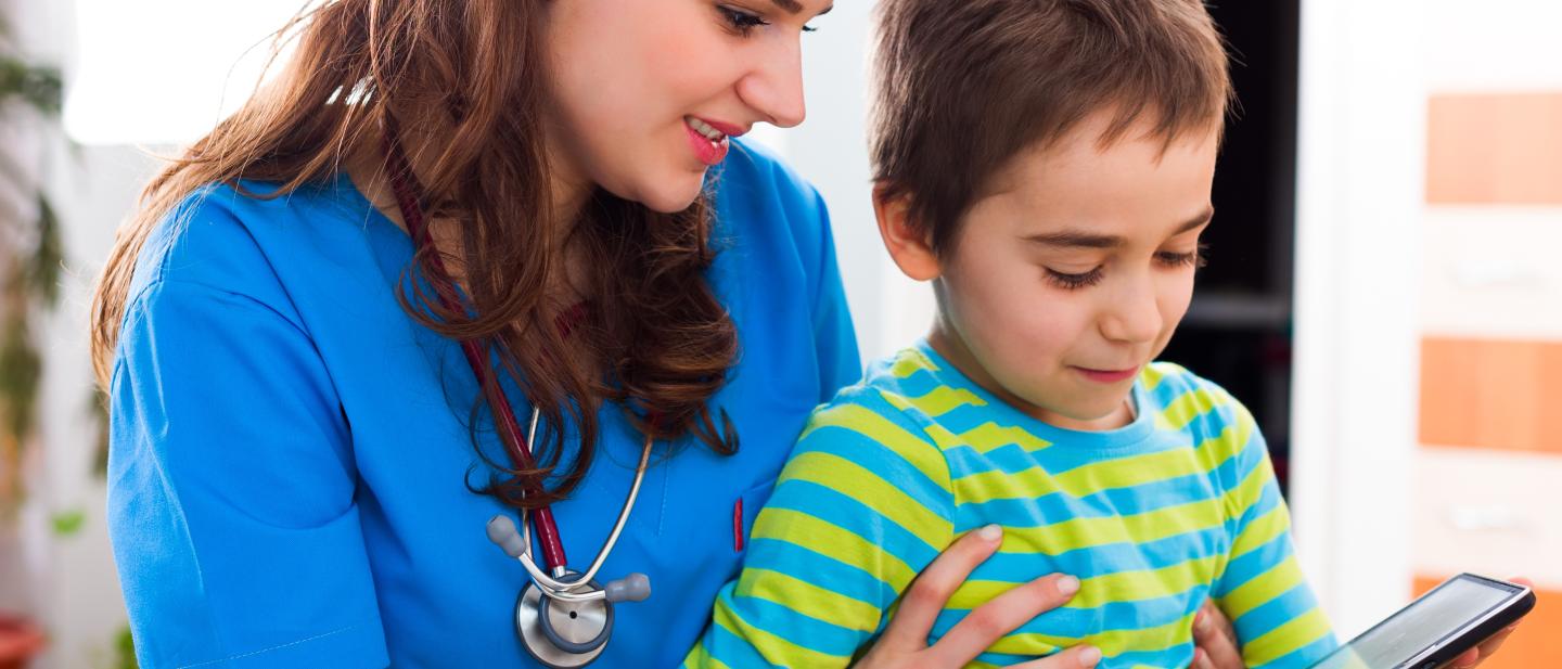 Female doctor sitting with a boy