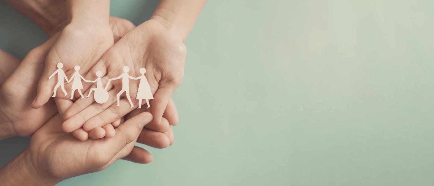 Group of hands holding a paper chain of people