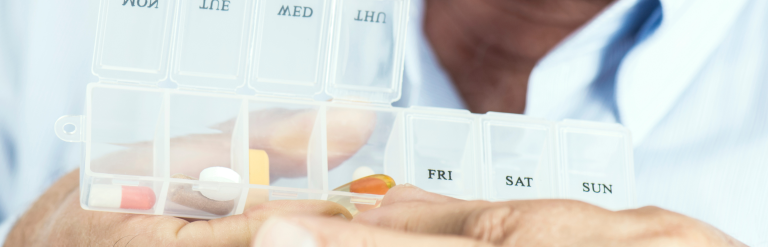 person holding weekly medication organisation box
