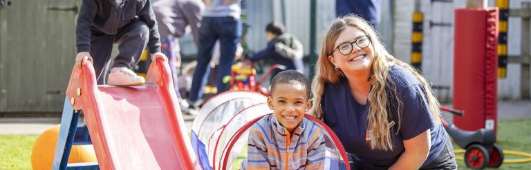 Women outside playing with child