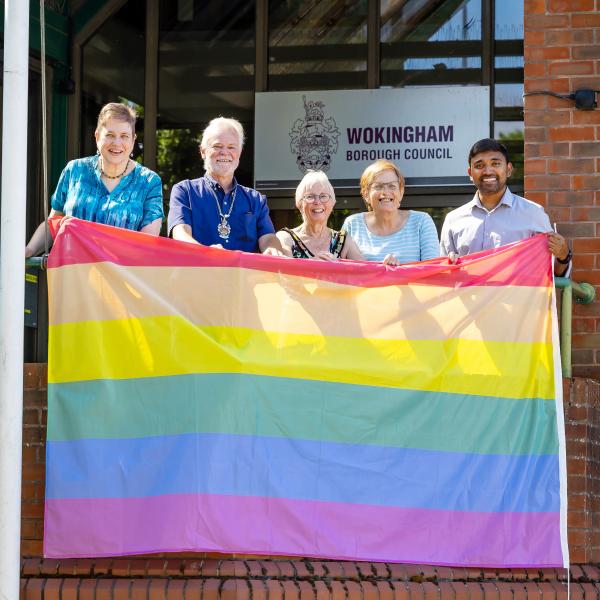 Wokingham Borough councillors raise the Pride rainbow flag at the council's Shute End offices